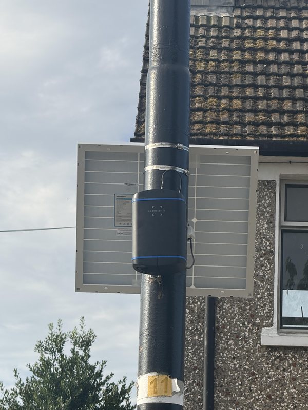 EarthSense Zephyr air quality monitor with a solar panel mounted on a street pole